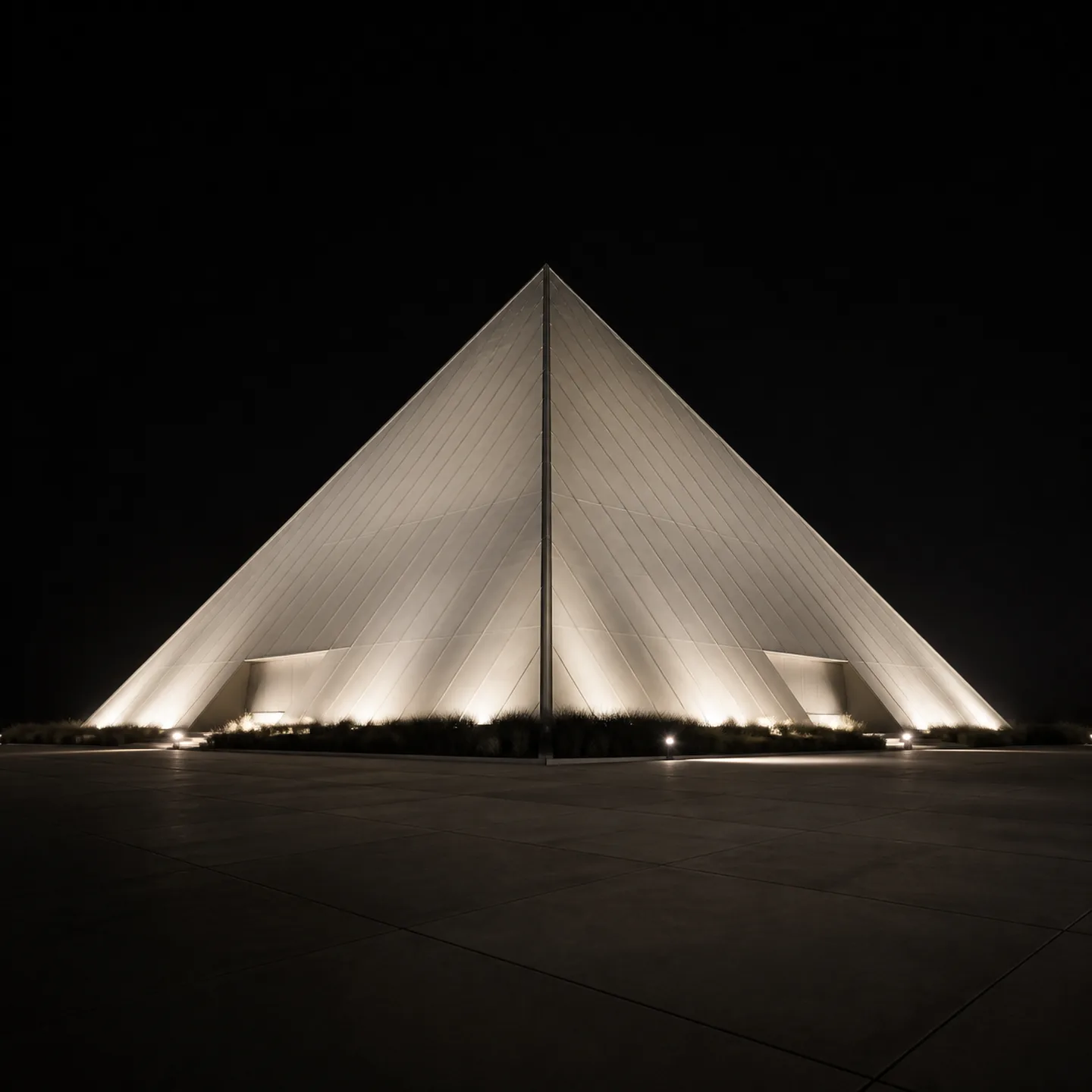 The Walter Pyramid rises above an empty arrival apron at night in Long Beach.